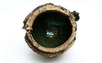 Small bowl with green interior and rugged rim