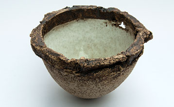 Small bowl with white interior and rugged rim