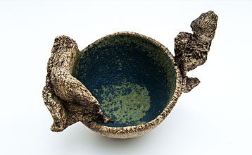 Small bowl with a matt blue/green interior and added 'wings'